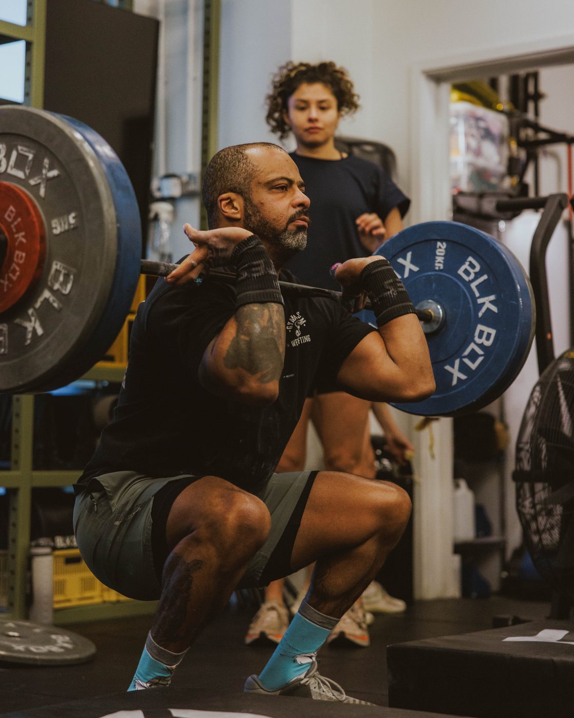 Member under load during a heavy barbell squat at Gymnasium