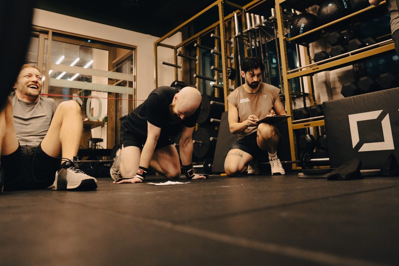 Coach recording scores with members after a class at Gymnasium