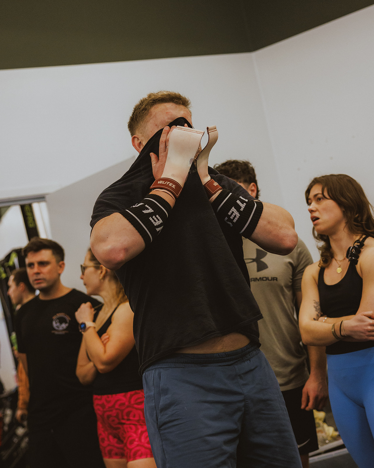 Coach guiding a member through a movement at Gymnasium