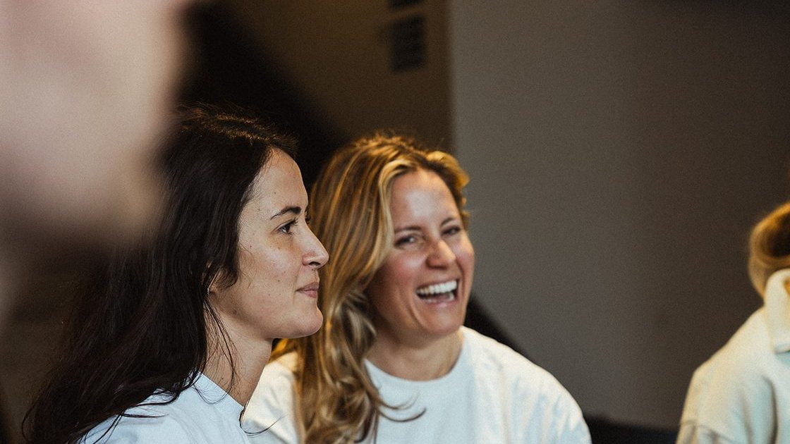 Two members laughing together after training