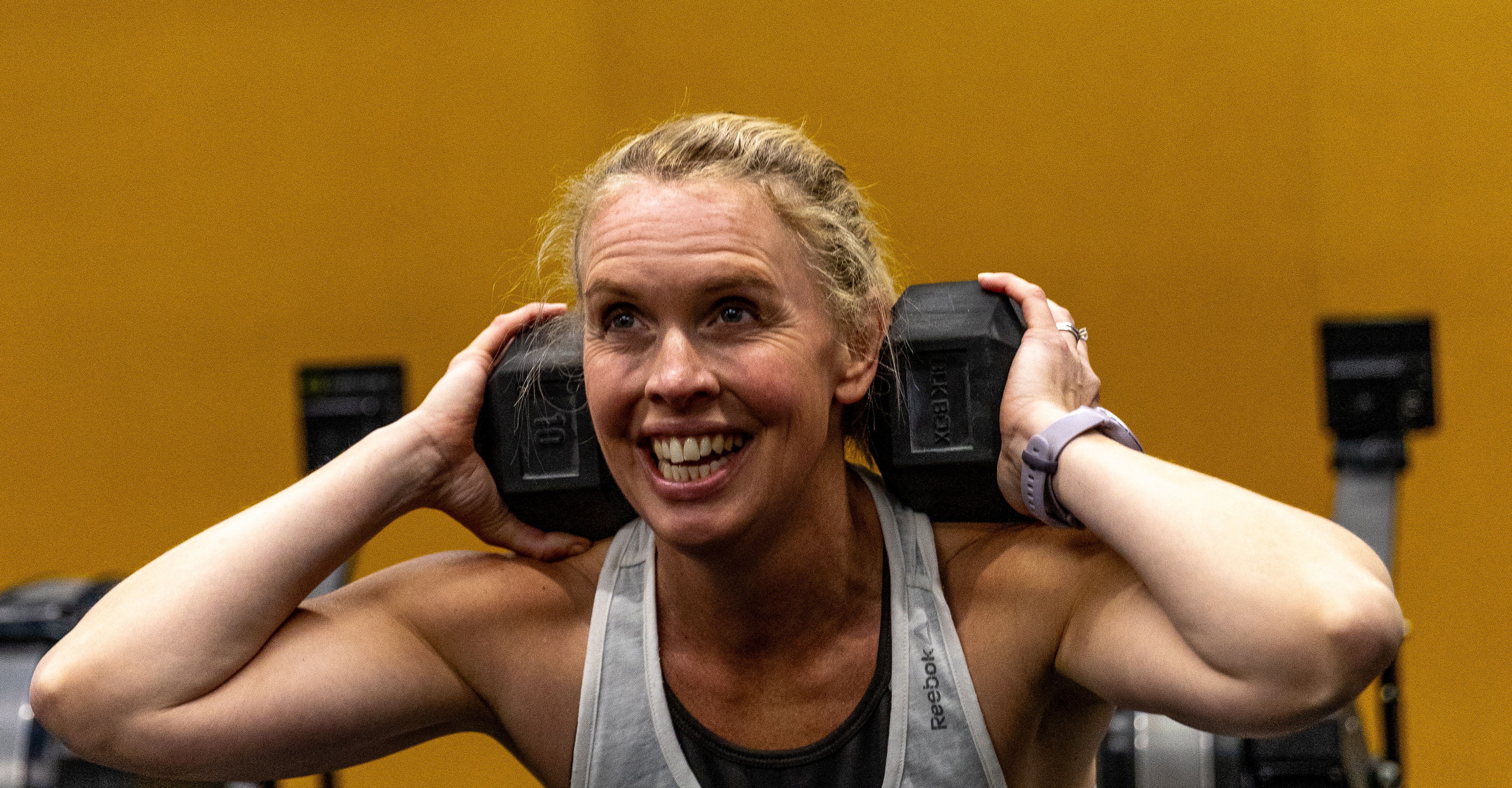 Woman strength training with weights and confidence