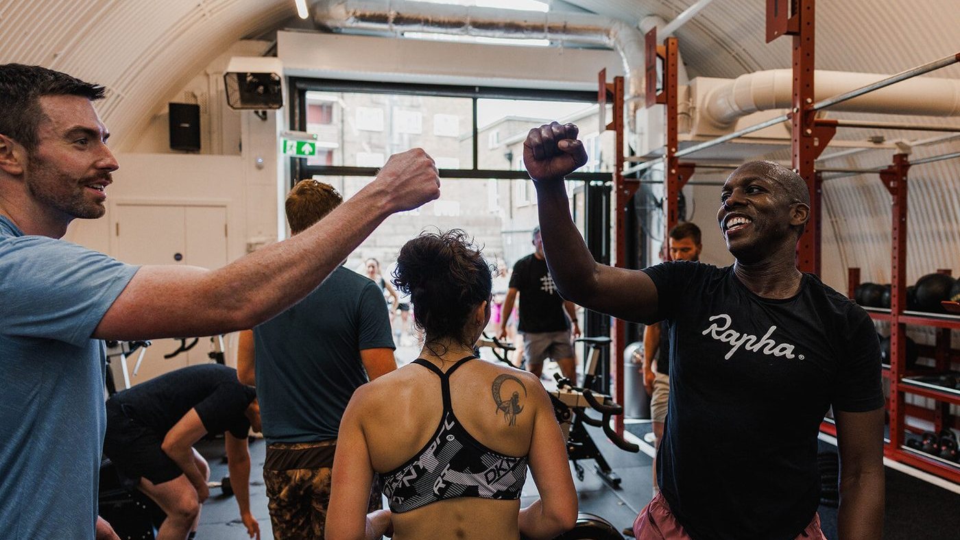 Giles fist-bumping a member after a session at Gymnasium