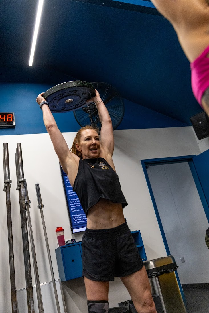 Women strength training with proper form and coaching