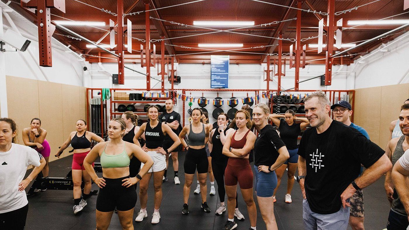 Coach briefing a class before a session at Gymnasium